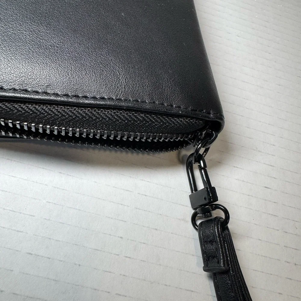 Betsey Johnson black faux leather zip-around wristlet/wallet